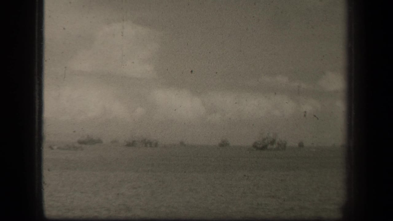 Supported by the clip metadata, this Leyte Gulf frame shows distant wartime vessels spread across a cloudy ocean horizon.
