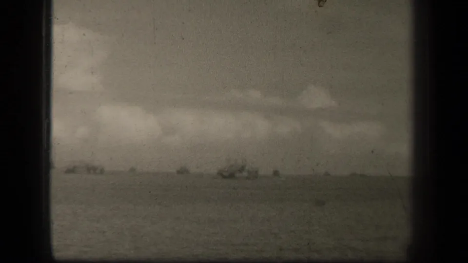 The final frame holds on distant ships in Leyte Gulf, with open sea, cloud cover, and visible 8mm film wear.