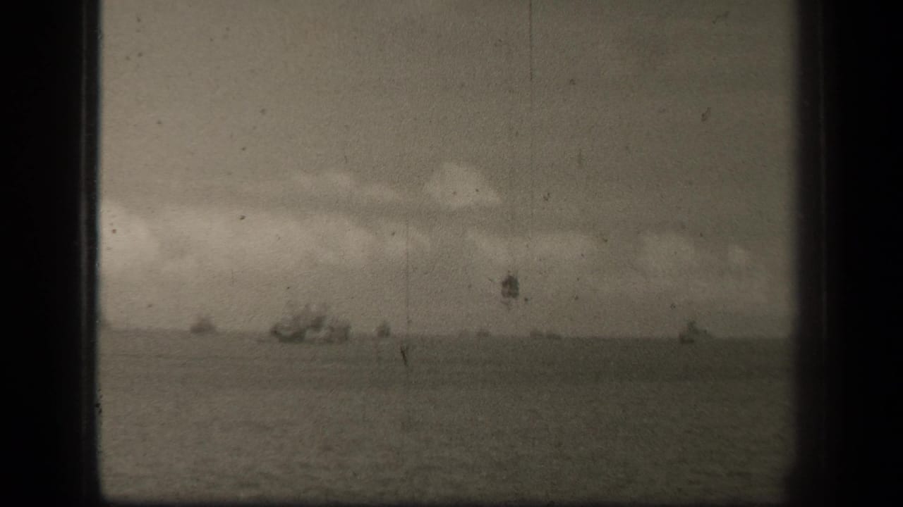 Cloudy horizon over water with several distant vessels.