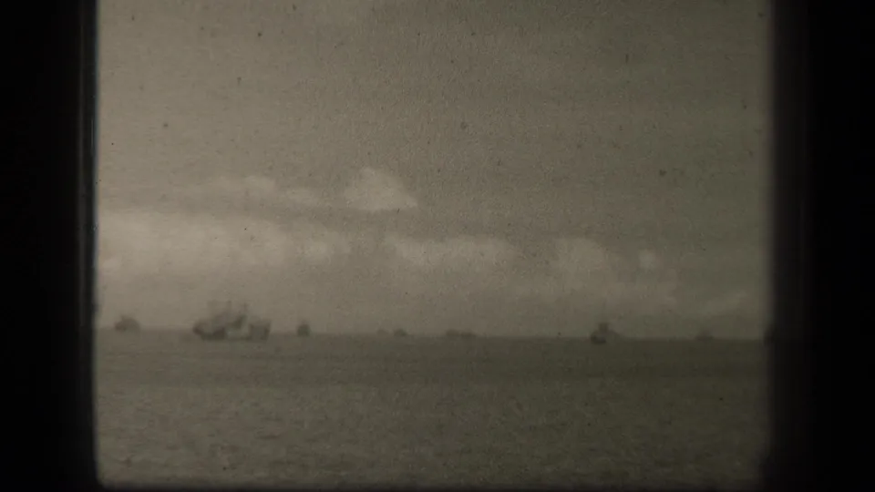 Soft black-and-white 8mm view of Leyte Gulf with faint vessels spread across the distant horizon.