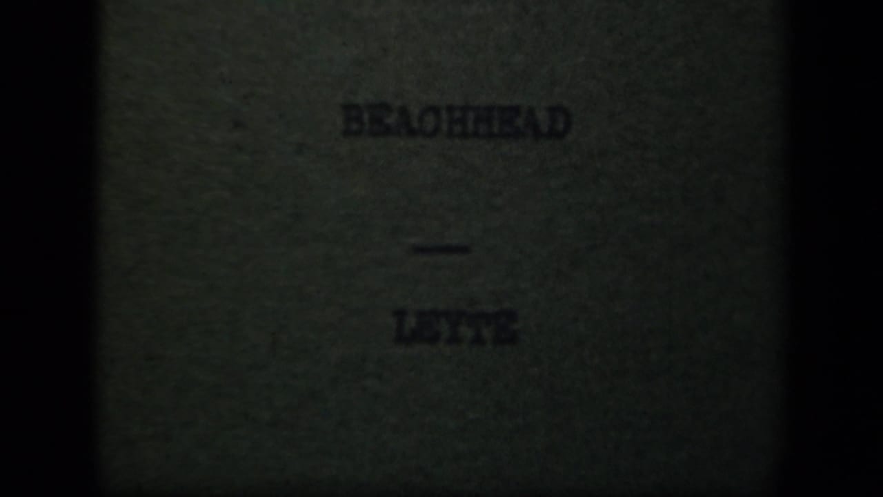 Dim 8mm title card reading “BEACHHEAD — LEYTE,” confirming the supplied Leyte Gulf wartime setting.