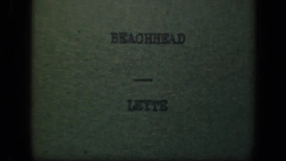 Final visible 8mm title-card frame reading “BEACHHEAD — LEYTE,” bordered by dark gate edges and mottled film texture.