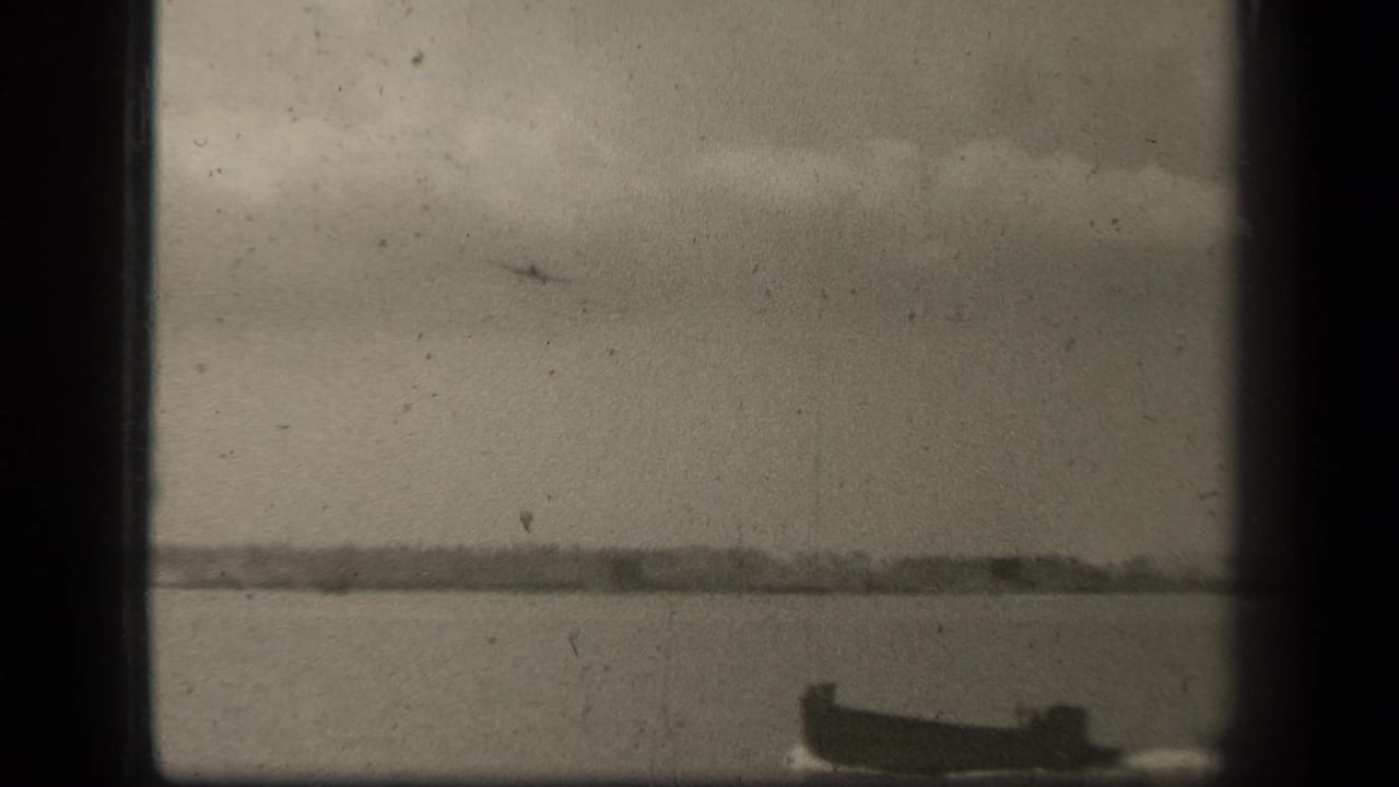 Leyte Gulf view with a small boat near the lower right and a distant aircraft silhouette crossing an overcast sky.