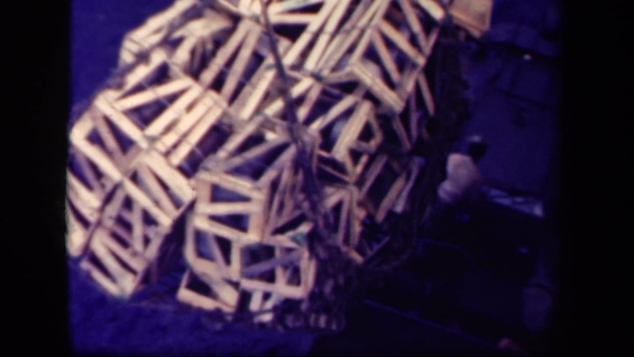 Stacked wooden crates on a dark deck with strong blue-purple film color shift.