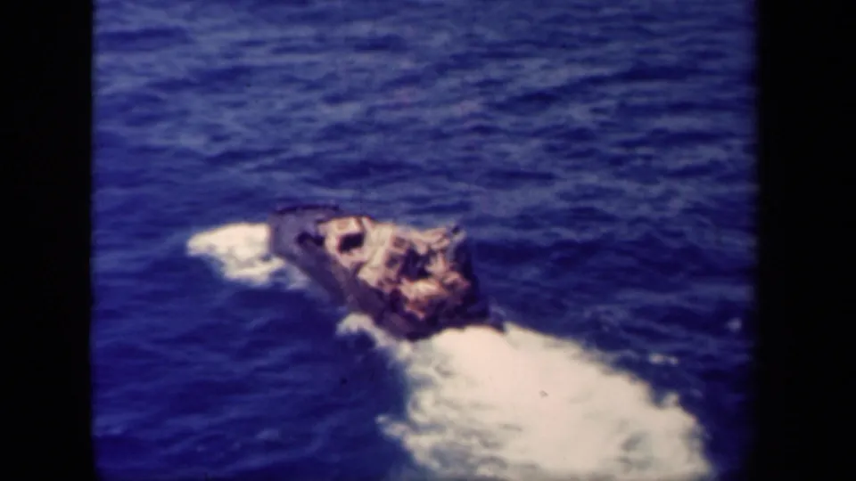 A cargo-bearing craft travels through blue water in 8mm wartime footage associated with Leyte Gulf in 1944.