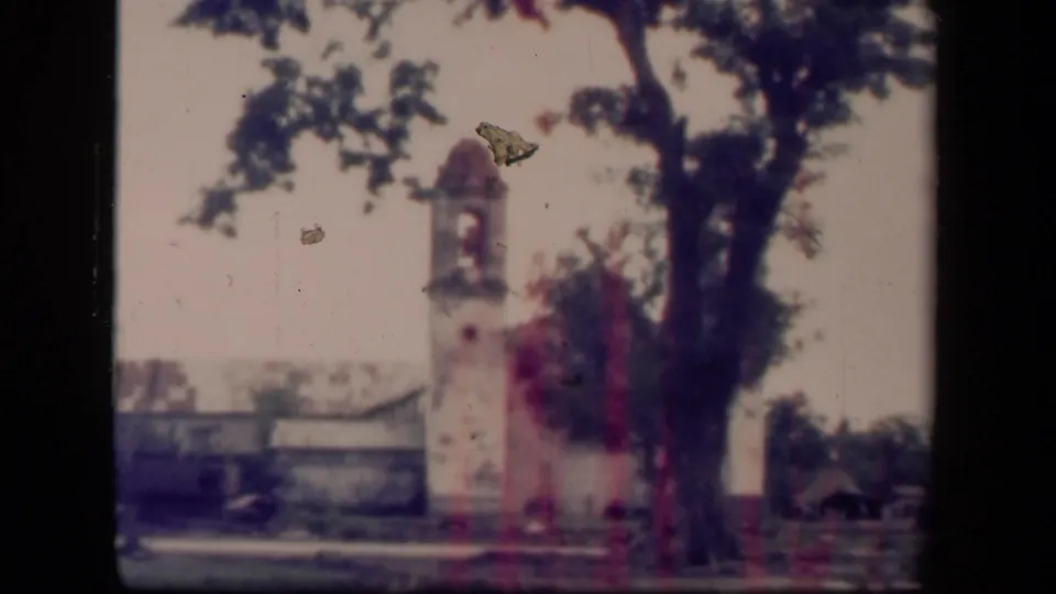 1944 Leyte Gulf footage appears to show a Tacloban church bell tower beside a tree, with damaged structures and film specks visible.