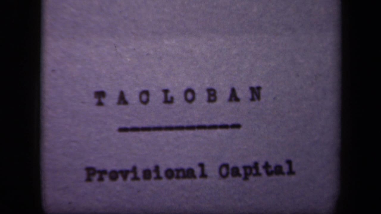 Typed title card reading Tacloban above Provisional Capital on purple-tinted film.