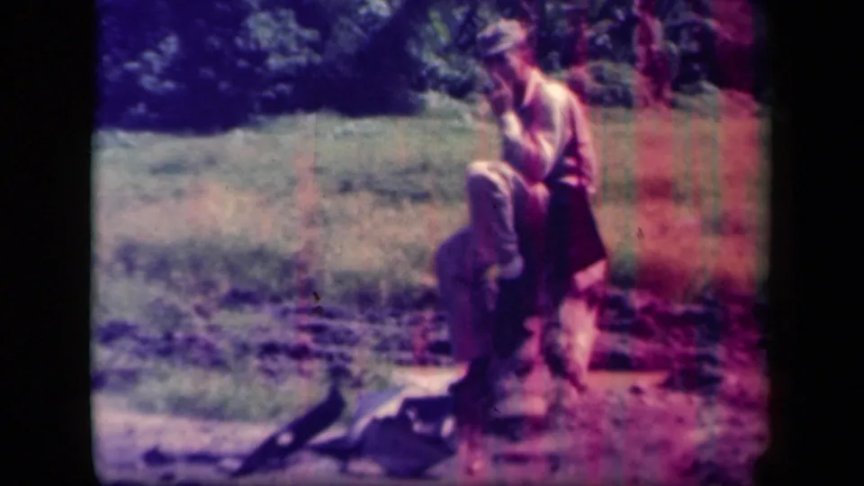 The soldier remains seated on the log, with tropical vegetation and dark gear-like shapes near the ground.