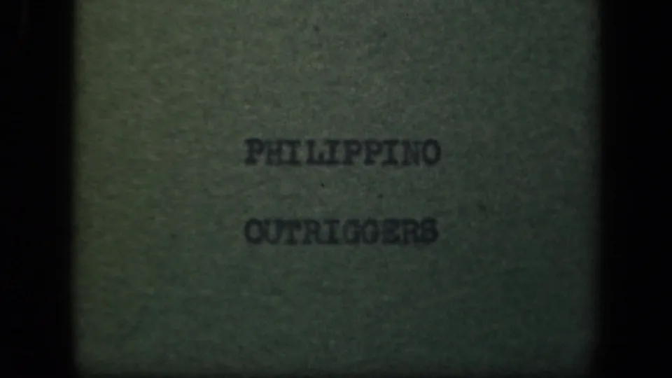 Later 8mm title-card frame from the 1944 Philippines clip, with “PHILIPPINO OUTRIGGERS” centered on a greenish card.