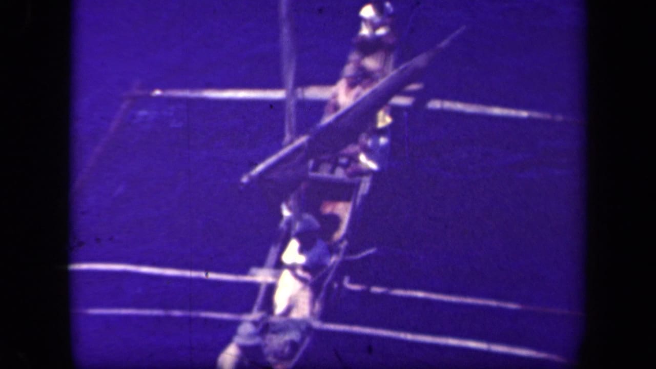Several men appear aboard a Filipino outrigger canoe on the waters of Leyte Gulf, seen in purple-blue shifted 8mm footage.
