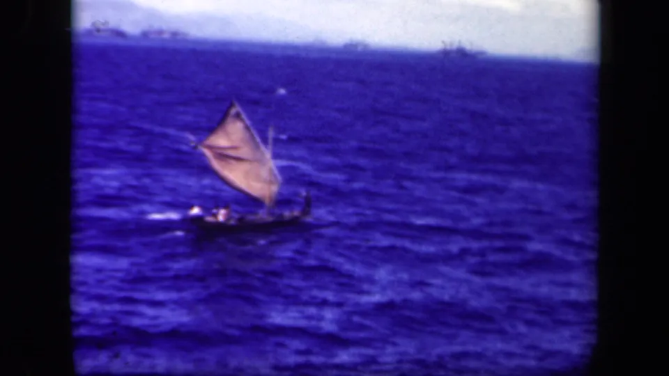 A distant crewed sailing vessel continues across rough Leyte Gulf water in saturated 8mm color.