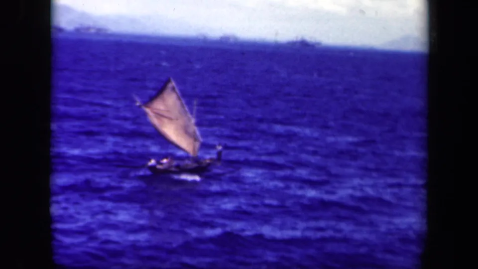 Final 1944 Leyte Gulf frame showing the small sailboat farther off against choppy sea and a faint shoreline.