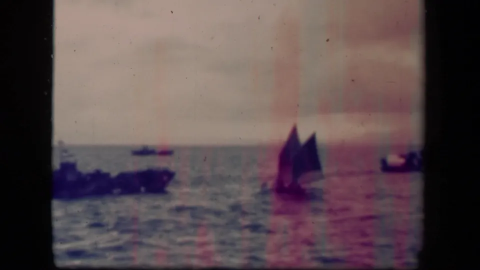 Final 8mm frame shows the sailboat farther off in Leyte Gulf, with surrounding boats and visible pink film aging streaks.
