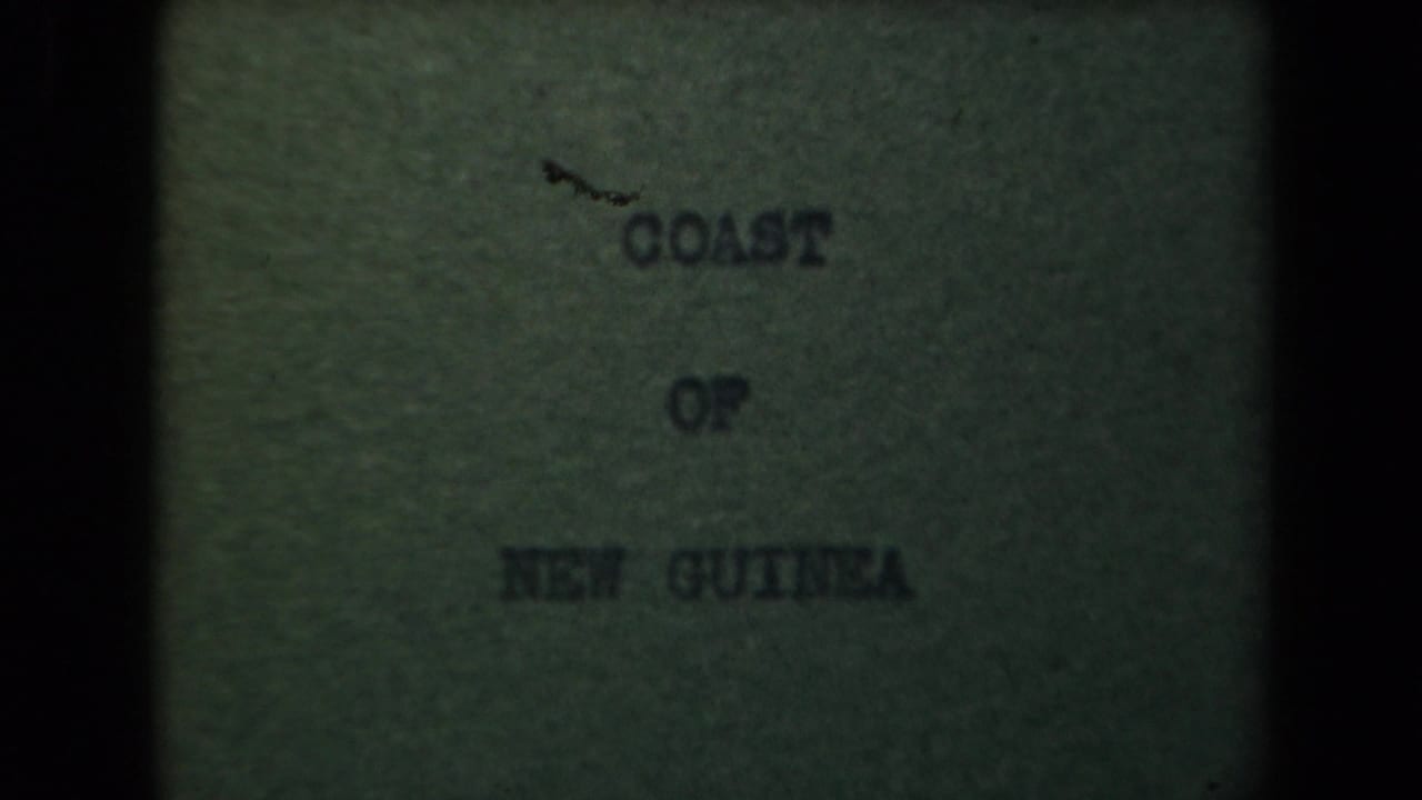 Faded title card reading Coast of New Guinea beside a dark film border.