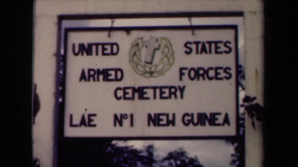 Final frame of the 1944 Papua New Guinea clip holds on the cemetery sign with the Lae No. 1 New Guinea text visible.