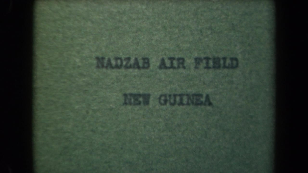 Green-tinted 1944 title card naming Nadzab Air Field and New Guinea, framed by dark scanned-film edges.