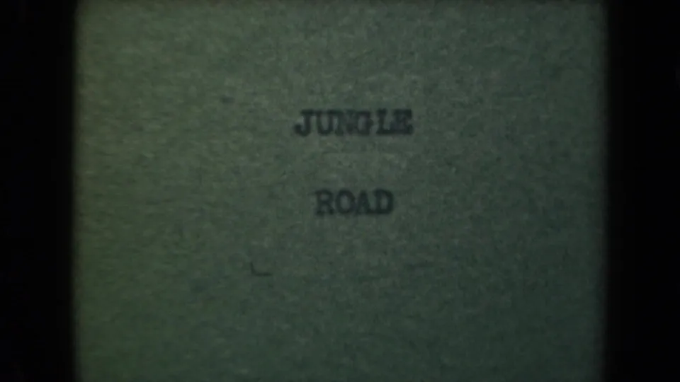 8mm title card from the clip showing centered JUNGLE ROAD text on a green textured background.