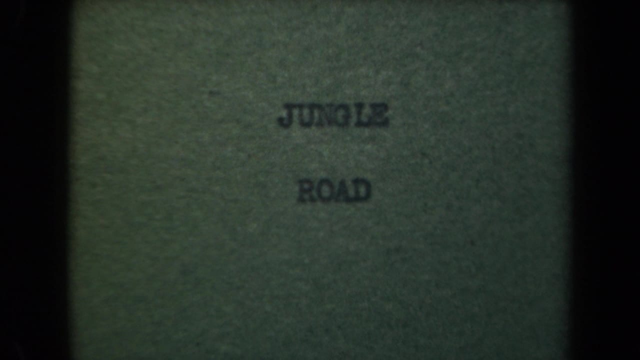 Faded 8mm title card reading jungle road, associated with the Papua New Guinea 1944 clip metadata.