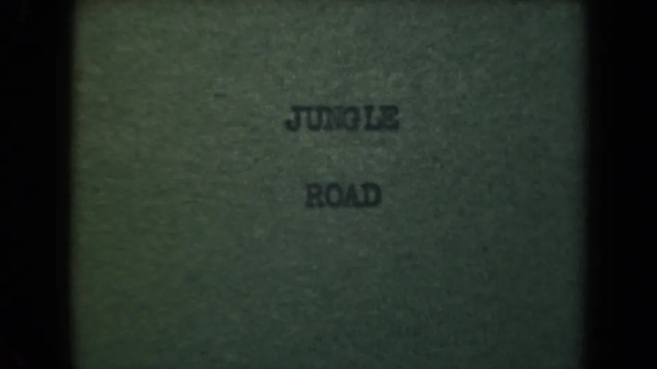 Faded 8mm title card reading jungle road, associated with the Papua New Guinea 1944 clip metadata.