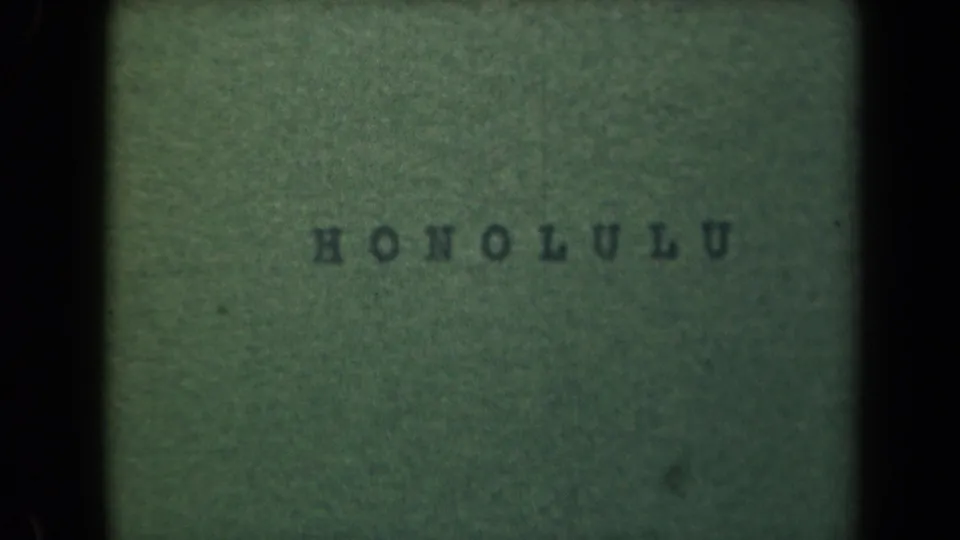Final 1944 Hawaii home-movie frame showing the Honolulu title card, centered on green paper with visible film grain and edge shadows.