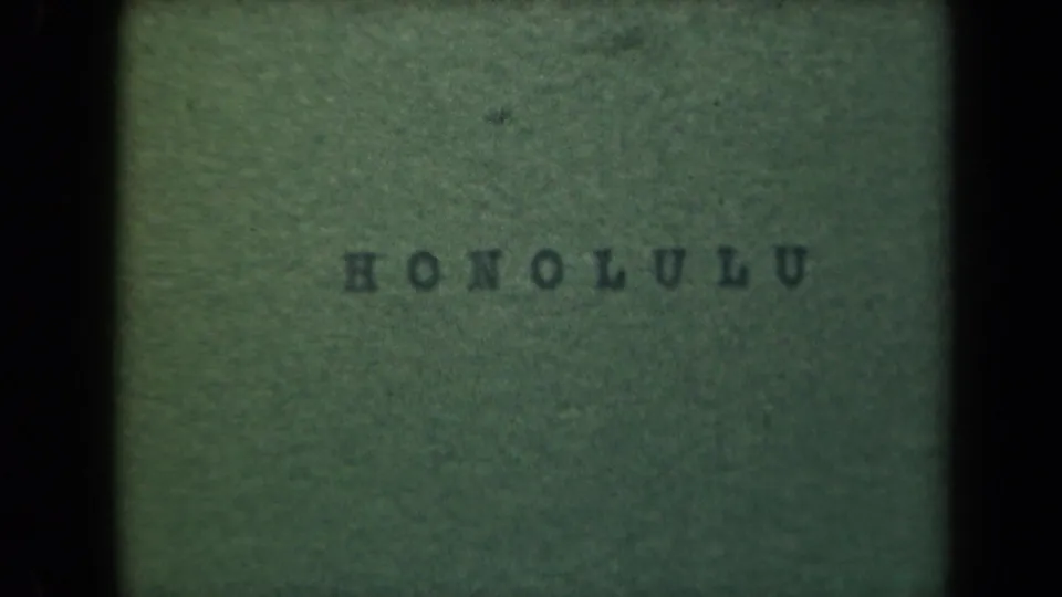 A soft green home-movie title card reads HONOLULU, with dark film borders and visible grain.