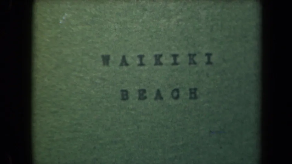 1944 Hawaii 8mm frame showing the WAIKIKI BEACH title card, softly focused with visible film grain.