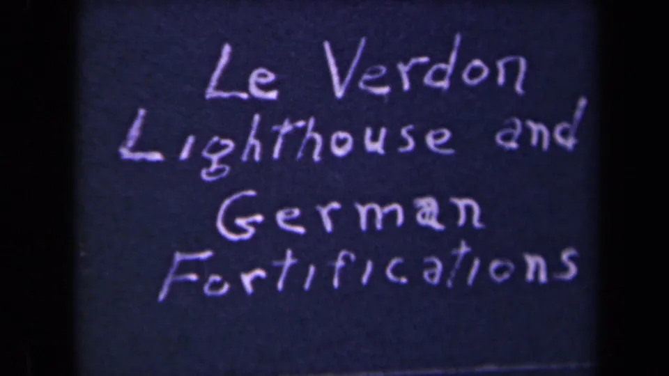 1945 8mm title card with handwritten white text naming Le Verdon Lighthouse and German Fortifications.