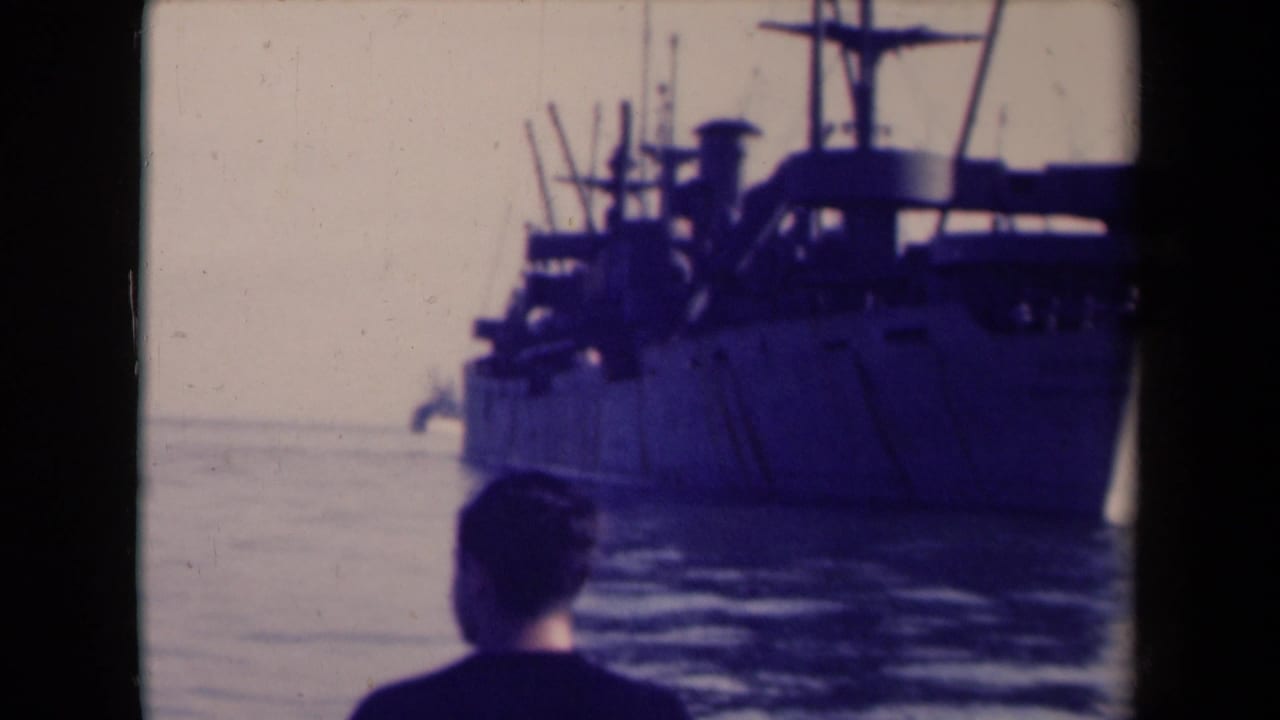 The camera frames the vessel more closely while the man's head remains at the bottom edge of the 8mm frame.