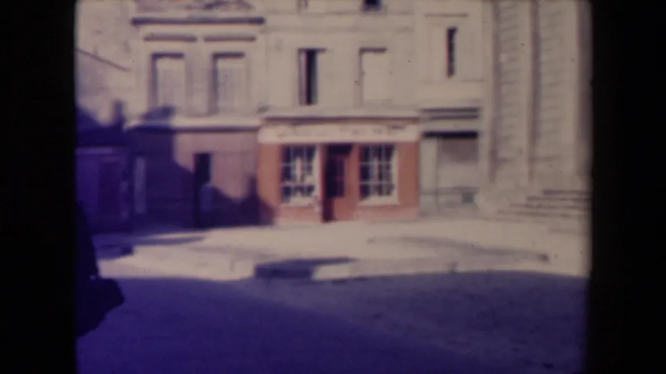 The French street view holds on the LACQUETAIN shopfront and stone facade as the pedestrian is mostly cropped at the left edge.