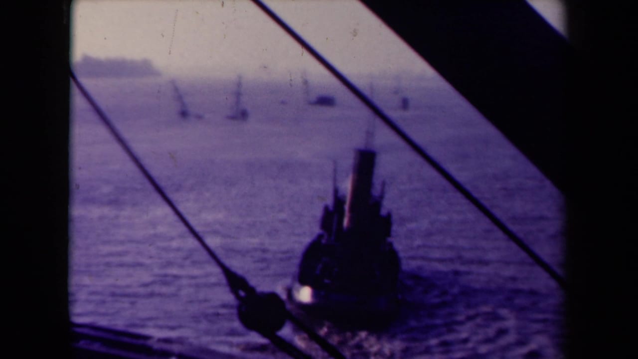 Tugboat seen through dark window framing and diagonal ropes on open water.
