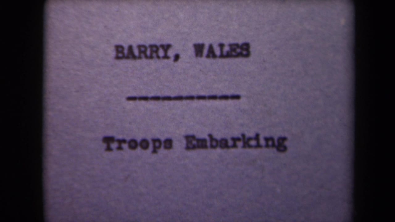 A soft, purple-tinted title card shows Barry, Wales and Troops Embarking within dark film borders.