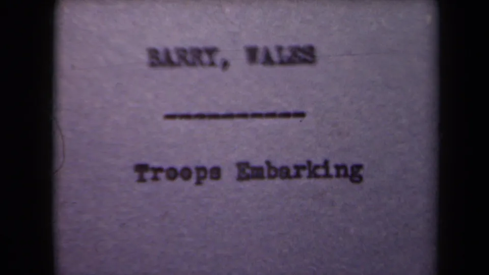 A filmed title card identifies Barry, Wales and Troops Embarking, supporting the clip's troop boarding subject.
