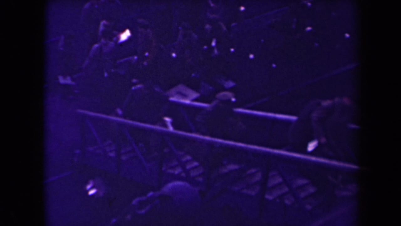 Soldiers move near a gangway or rail in a dark dockside scene.
