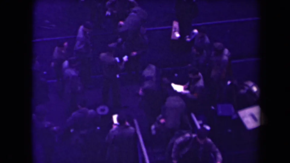 A handheld high-angle view shows soldiers clustered around the ramp area with packs and small supplies visible in the dim scene.