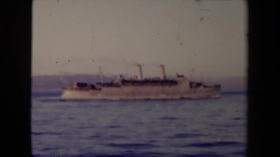 The steamship remains centered on calm water, its two funnels visible against a hazy French coastal backdrop supported by clip metadata.