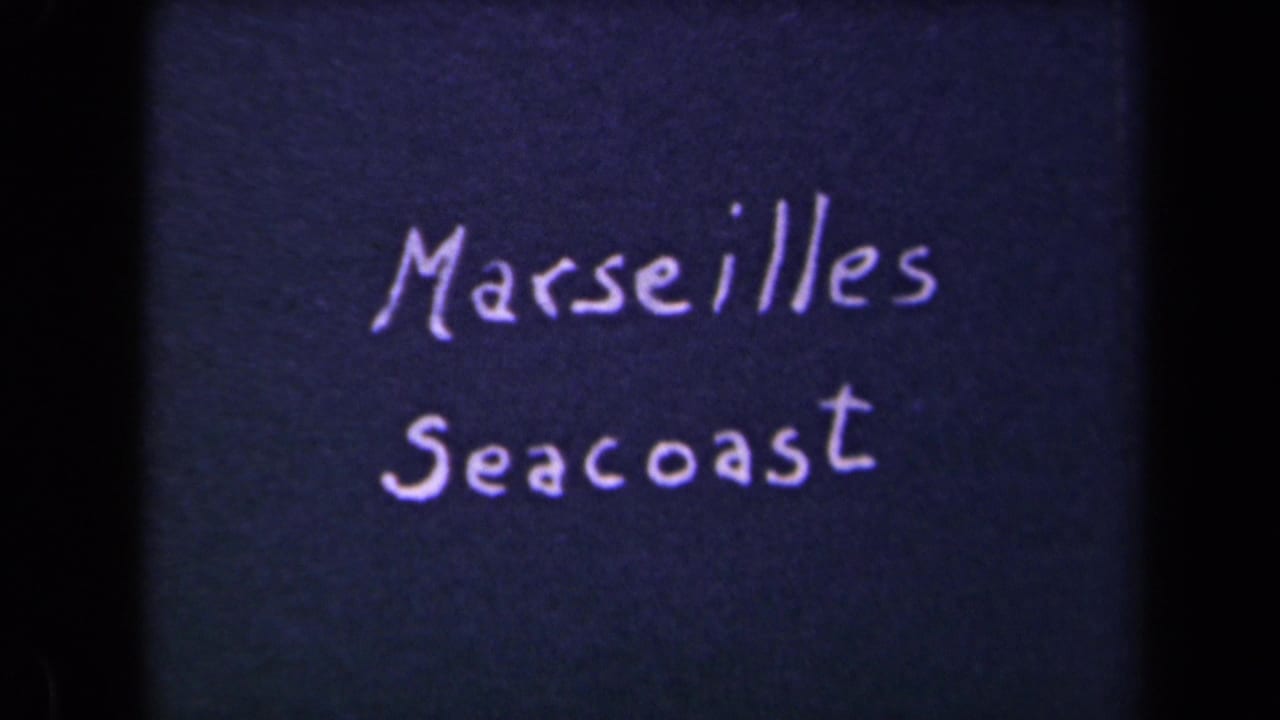 Another 8mm frame of the handwritten Marseilles Seacoast card, with visible grain and dark film borders.