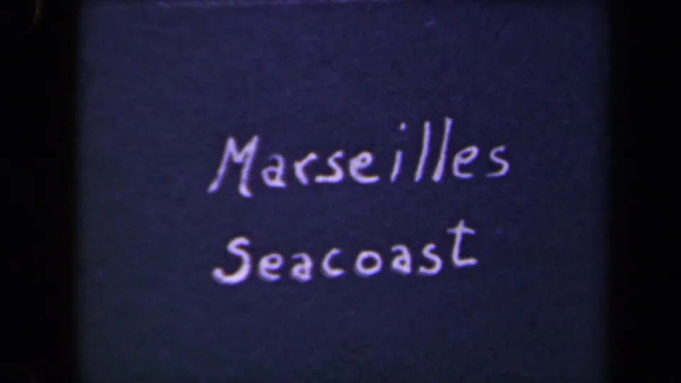 1940s 8mm title card reading Marseilles Seacoast, written in white lettering against a dark background.