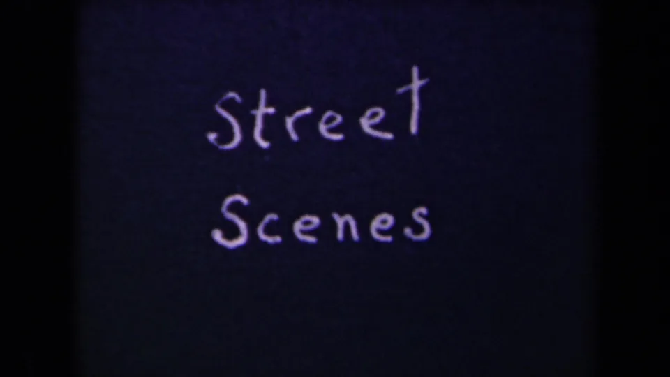 Handwritten Street Scenes title card in white lettering on dark blue 8mm film, framed by black contact-sheet borders.