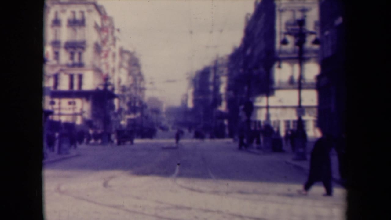 Wide city street with pedestrians along both sides and buildings receding into the distance.