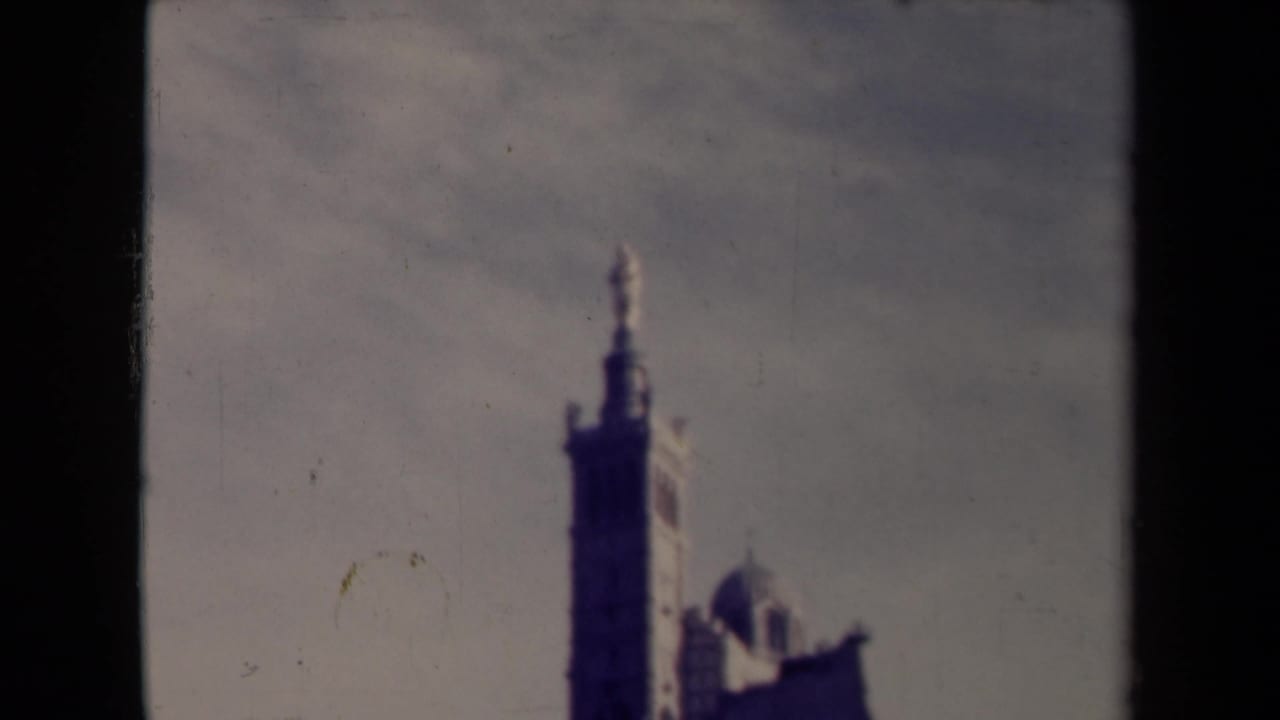 Tall tower and domed roofline repeated in a soft 8mm contact-sheet frame.