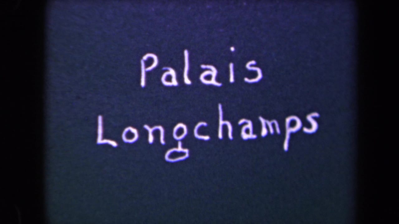 Second view of handwritten “Palais Longchamps” title on a dark surface.