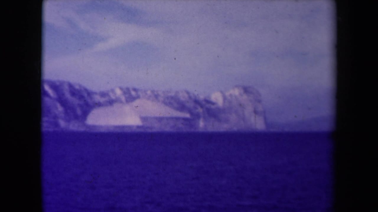 Distant icy coastline beyond blue water with dark 8mm frame borders.