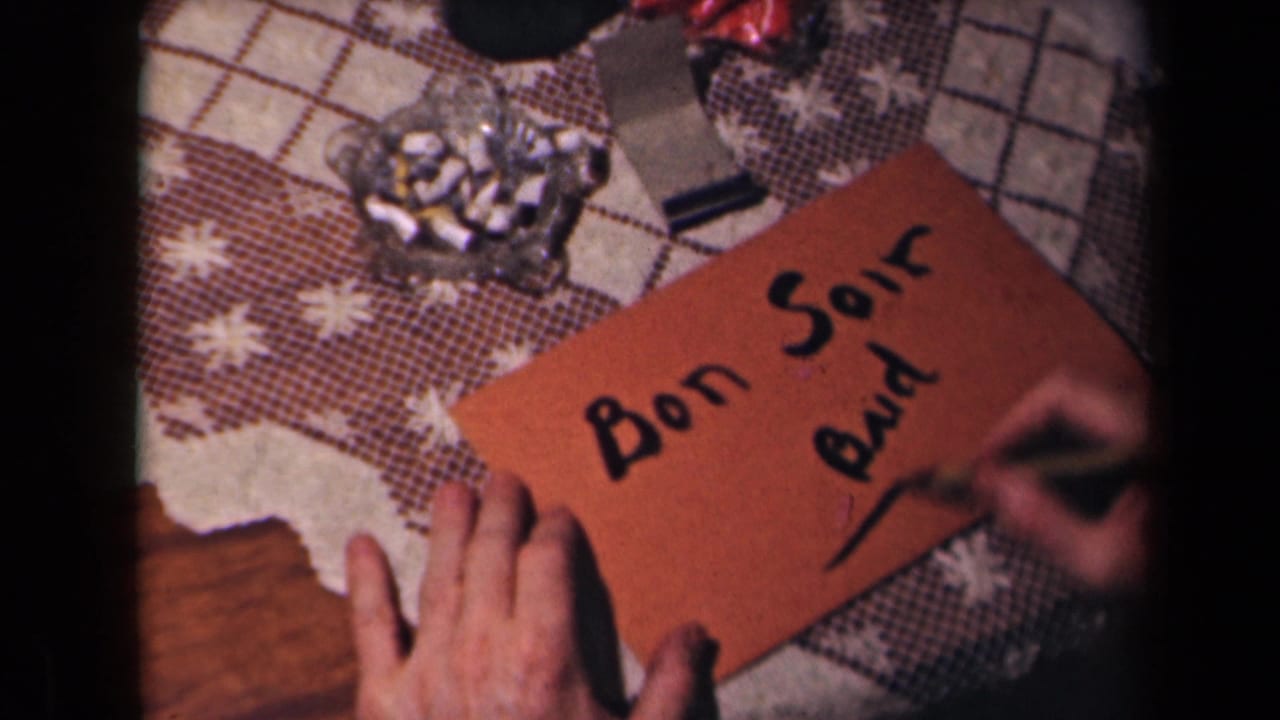 A hand draws a line under "Bud" on a brown card with "Bon Soir" written above it.