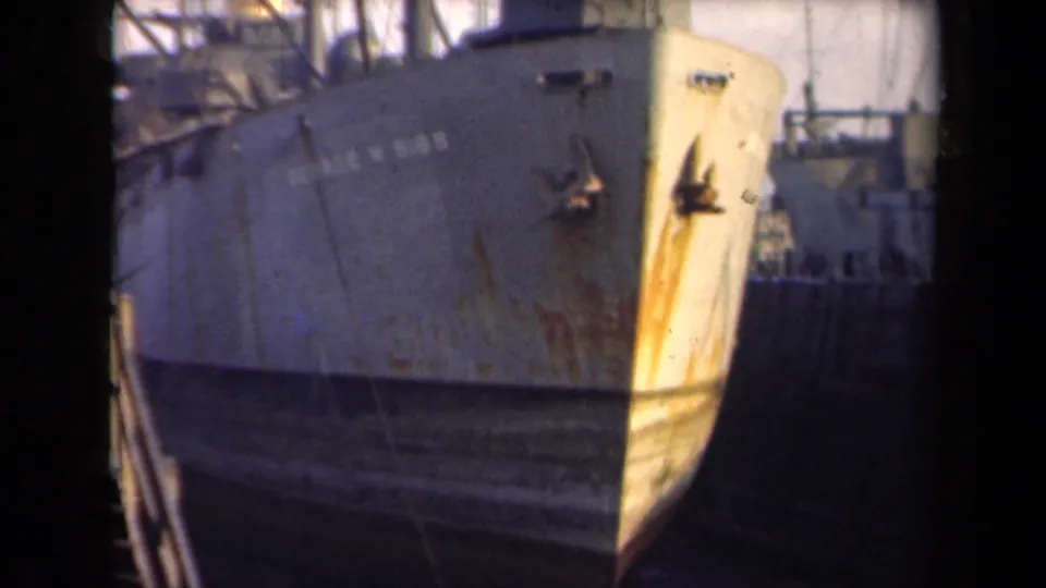Dockside view of the SS Geo. M. Bibb bow in Rotterdam-associated 1946 footage, with rust streaks and rigging visible.