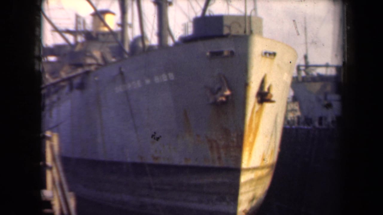 The George W. Gibbs appears docked in the Netherlands, seen in faded 8mm color with its bow and deck equipment visible.