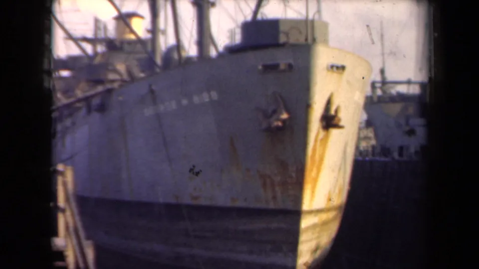 The George W. Gibbs appears docked in the Netherlands, seen in faded 8mm color with its bow and deck equipment visible.