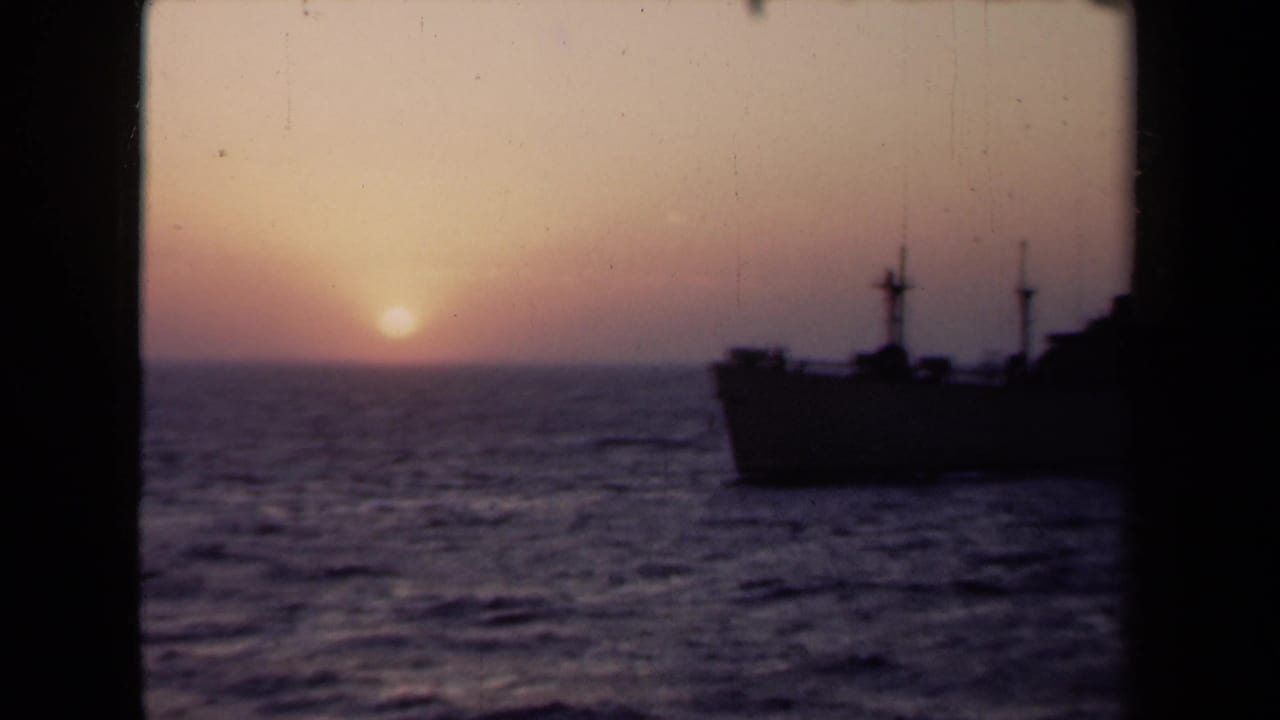 1946 Netherlands 8mm frame with a ship silhouette at right, choppy sea, and sunset light along the horizon.