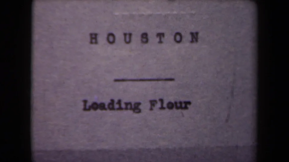 Repeated 8mm title card for the flour-loading scene, with Houston printed above Loading Flour.