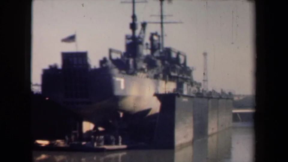 End frame of the 1946 Netherlands harbor shot, with the large American warship still docked beside the pier.