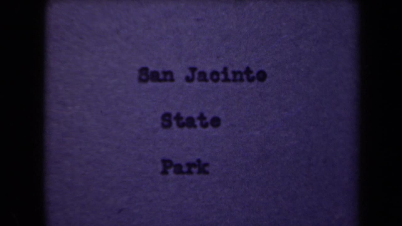 Purple 8mm title card with typewriter-style lettering reading San Jacinto State Park, framed by dark film edges.
